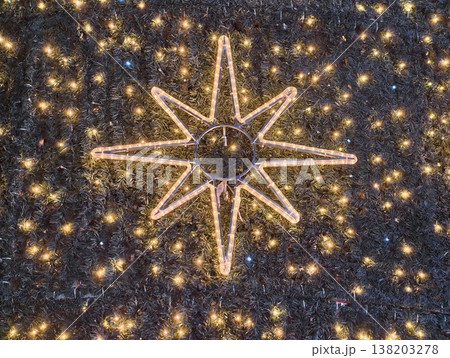 Festive decorative symbol, Bright star motif featuring twinkling lights and decorative elements Festive decorative symbol, Bright star motif featuring twinkling lights and decorative elements 138203278