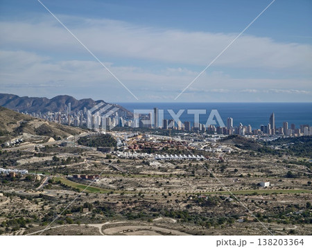 Seaside towers appear, Vivid landscape features coastal defenses against sprawling plains and ocean view 138203364