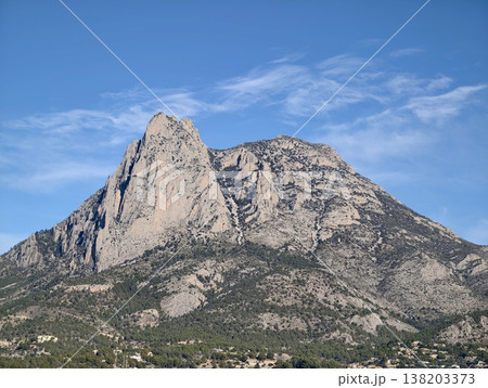 Jagged summit with detailed rocky features, Majestic cliff face showcasing crags and deep fissures 138203373