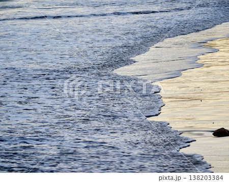 Serene seaside settings showcasing luminous sunlight and tranquil ocean surfaces for promotional use 138203384