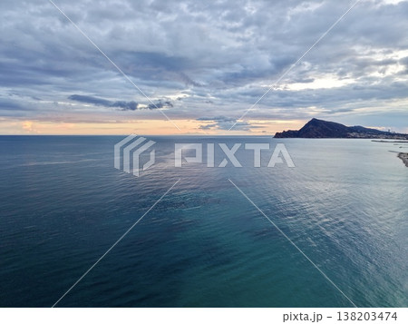 Quiet sea horizon with soft cloud coverage and faroff headlands fosters meditative thought and storytelling Quiet sea horizon with soft cloud coverage and faroff headlands fosters meditative thought and storytelling 138203474