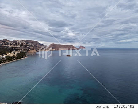 Mysterious seascape under gloomy cloud cover, Quiet horizon over open waters with muted colors and islands Mysterious seascape under gloomy cloud cover, Quiet horizon over open waters with muted colors and islands 138203492