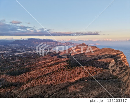 Golden hour overlooking hills and ocean, Beautiful coastal ridge with mountain range at sunset time Golden hour overlooking hills and ocean, Beautiful coastal ridge with mountain range at sunset time 138203517