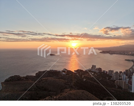 Bright sunset with scenic bay, Vivid evening scene featuring vibrant sky and peaceful shoreline view 138203520