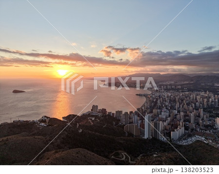 Serene port view at dusk, Still nightfall over harbor with urban skyline reflecting soft sunset colors 138203523
