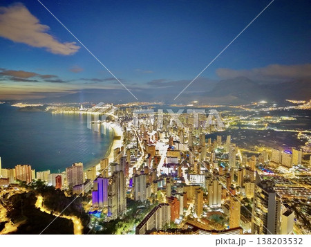 Evening illumination reveals flourishing skyscrapers and resorts enticing investor interest 138203532