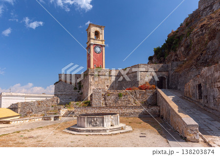 Clock tower and stone walls of Old Fortress in Corfu Town, Greece Clock tower and stone walls of Old Fortress in Corfu Town, Greece 138203874