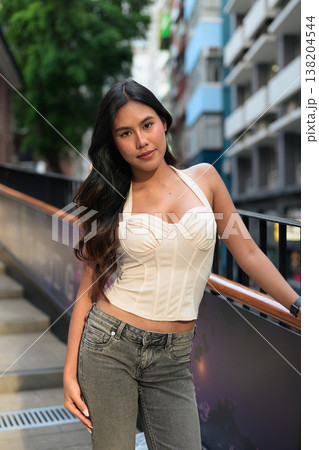 Asian Woman Smiling on Outdoor Stairs in Hong Kong Asian Woman Smiling on Outdoor Stairs in Hong Kong 138204544