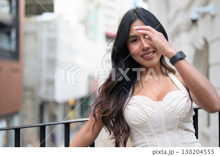 Asian Woman Smiling on Balcony in Central Hong Kong Asian Woman Smiling on Balcony in Central Hong Kong 138204555