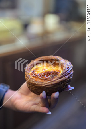Egg Tart Held by Hand in Hong Kong Egg Tart Held by Hand in Hong Kong 138204593