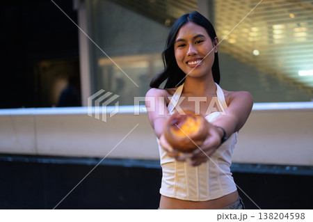 Smiling Thai Woman Offering Egg Tart in Hong Kong 138204598
