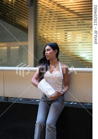 Thai Woman Holding Egg Tart on Hong Kong Street Thai Woman Holding Egg Tart on Hong Kong Street 138204602