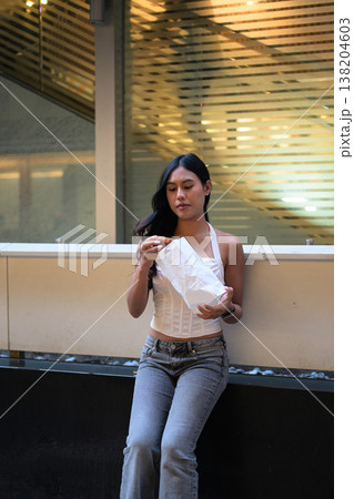 Thai Woman Holding Egg Tart on Hong Kong Street Thai Woman Holding Egg Tart on Hong Kong Street 138204603
