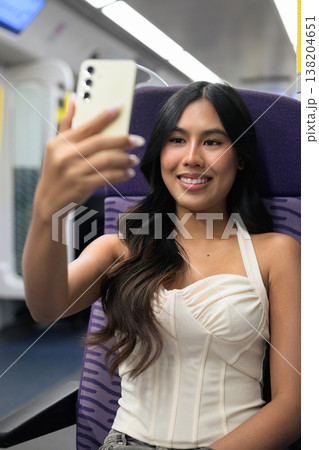 Asian Woman Taking Selfie on Hong Kong Train Asian Woman Taking Selfie on Hong Kong Train 138204651