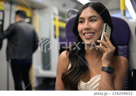 Asian Woman Talking on Smartphone in Hong Kong Train 138204652