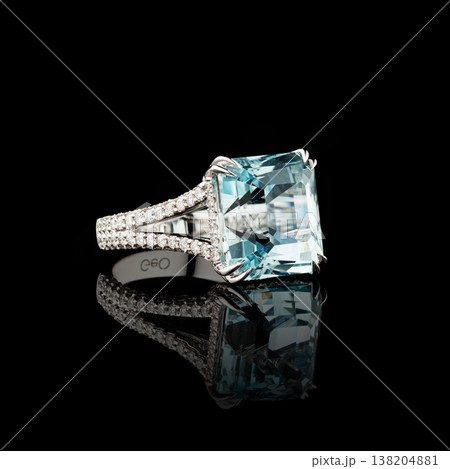 Beautiful white gold ring with diamonds and aquamarine on a black background 138204881
