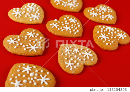 beautiful hand-baked cookies in the shape of a heart on a red background 138204898