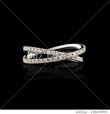 Beautiful white gold ring with diamonds on a black background close-up 138204954