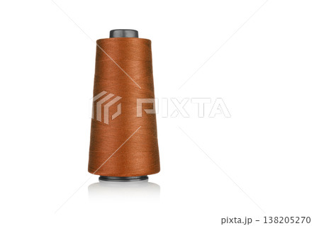 spool of industrial threads of brown color, texture of threads on a white background spool of industrial threads of brown color, texture of threads on a white background 138205270