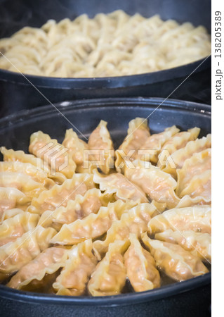 Fried dumplings on frying pan. Traditional food 138205389