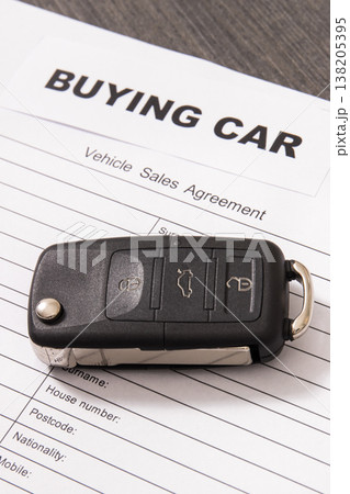 Car key, inscription buying car and vehicle sales agreement. Sales or purchases new or used vehicle Car key, inscription buying car and vehicle sales agreement. Sales or purchases new or used vehicle 138205395