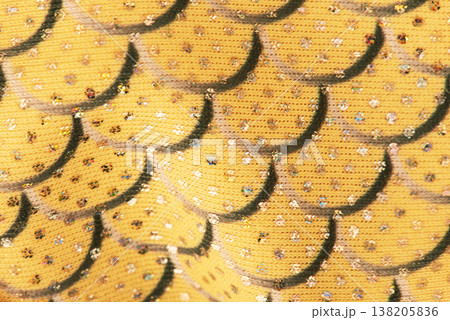 Yellow fabric texture with sequins and a mermaid scale pattern. 138205836