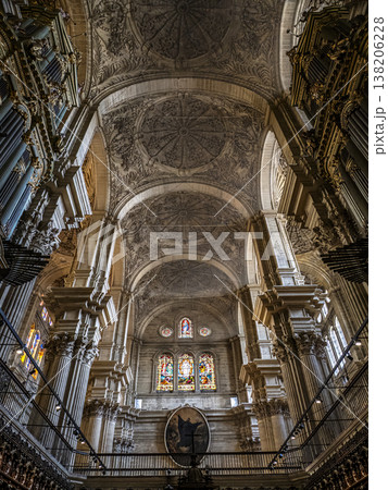 Malaga Cathedral Interior With Ornate Vaulted Ceiling, Stained Glass Windows, Marble Columns And Pipe Organs 138206228