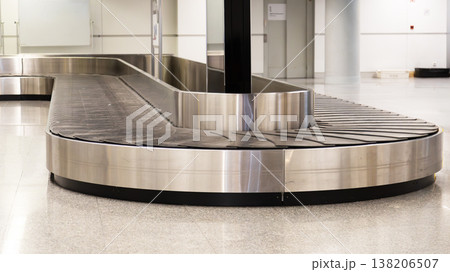 Empty airport baggage carousel with number sign in modern terminal interior waiting arriving luggage. 138206507