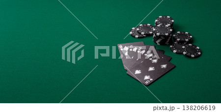 Playing cards and chips on a green cloth, a gambling game of poker. Cards and chips 138206619