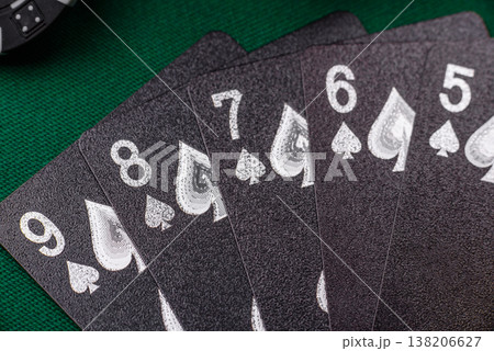 Playing cards and chips on a green cloth, a gambling game of poker. Cards and chips 138206627