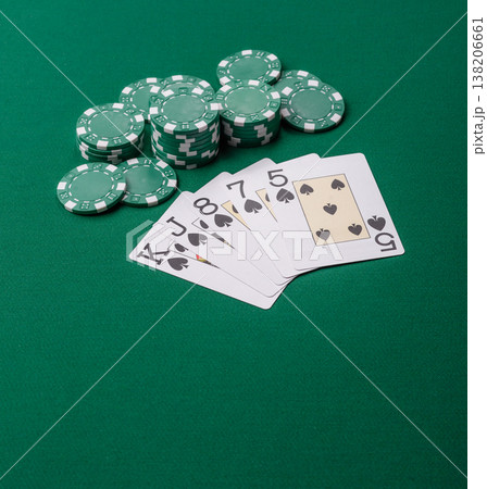 Playing cards and chips on a green cloth, a gambling game of poker. Cards and chips Playing cards and chips on a green cloth, a gambling game of poker. Cards and chips 138206661