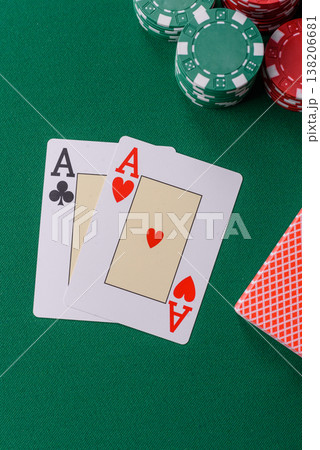 Playing cards and chips on a green cloth, a gambling game of blackjack or baccarat. Cards and chips Playing cards and chips on a green cloth, a gambling game of blackjack or baccarat. Cards and chips 138206681