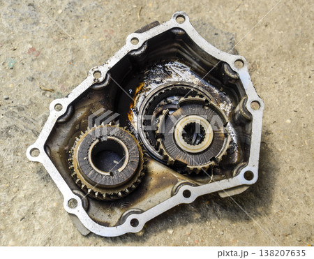 Dismantled box car transmissions. Gear with bearings and gearbox housing. The gears on the shaft of a mechanical transmission. Dismantled box car transmissions. Gear with bearings and gearbox housing. The gears on the shaft of a mechanical transmission. 138207635