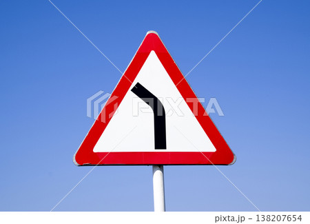 Road sign dangerous turn. Warning sign. 138207654