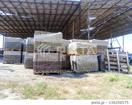 Tiles piled in pallets. Warehouse paving slabs in the factory for its production. Tiles piled in pallets. Warehouse paving slabs in the factory for its production. 138208575