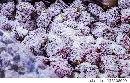 Pieces of marmalade in coconut flakes. Sweets with coconut. 138208699