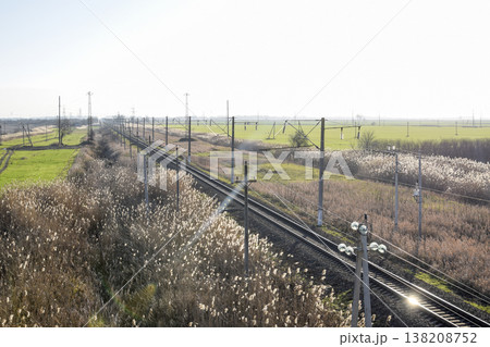 Plot railway. Top view on the rails. High-voltage power lines for electric trains Plot railway. Top view on the rails. High-voltage power lines for electric trains 138208752