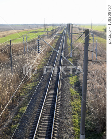 Plot railway. Top view on the rails. High-voltage power lines for electric trains Plot railway. Top view on the rails. High-voltage power lines for electric trains 138208757