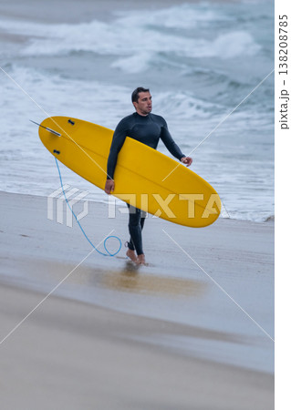 Surfer with board under his arm 138208785
