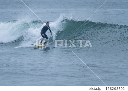 Surfer in action on the ocean waves Surfer in action on the ocean waves 138208791