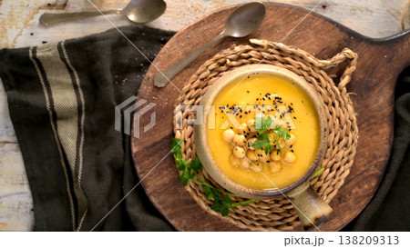 Creamy Chickpea Soup Garnished with Black Sesame Seeds and Parsley in a Rustic Ceramic Bowl Creamy Chickpea Soup Garnished with Black Sesame Seeds and Parsley in a Rustic Ceramic Bowl 138209313