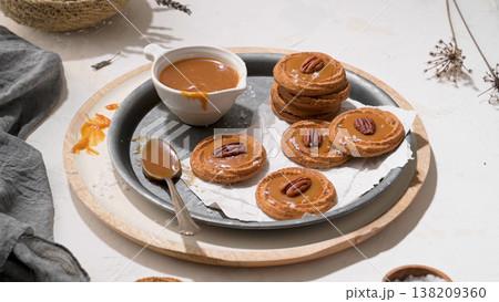 Gourmet Pecan Caramel Cookies with Sea Salt on Rustic Tray Gourmet Pecan Caramel Cookies with Sea Salt on Rustic Tray 138209360