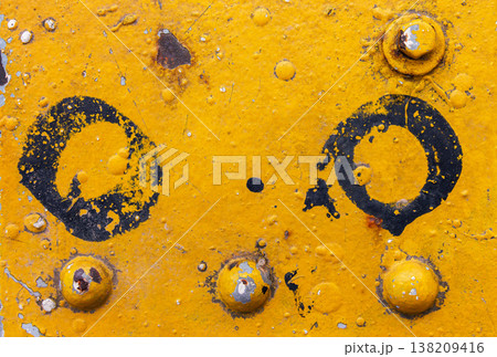 Yellow painted metal surface with rivets, rust, dirt, and black circle paint marks. industrial grunge texture background Yellow painted metal surface with rivets, rust, dirt, and black circle paint marks. industrial grunge texture background 138209416