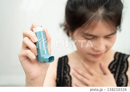 Asthma and chronic obstructive pulmonary disease COPD, Asian teenage using metered dose inhaler MDI. Asthma and chronic obstructive pulmonary disease COPD, Asian teenage using metered dose inhaler MDI. 138210326