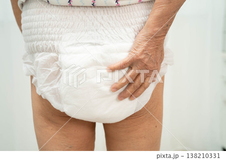 Asian senior woman patient wearing adult incontinence diaper pad in hospital. 138210331