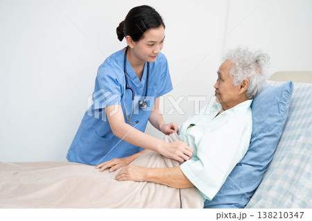 Asian doctor checking and treat elderly woman patient health in hospital. Asian doctor checking and treat elderly woman patient health in hospital. 138210347