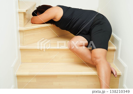 Asian lady fall down the stairs and pain at hip and waist because slippery surfaces. Asian lady fall down the stairs and pain at hip and waist because slippery surfaces. 138210349