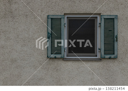 Turquoise shutters and window on textured wall with copy space Turquoise shutters and window on textured wall with copy space 138211454