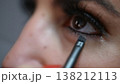 Beauty Trends and Self-Care Rituals Close-up of Woman Applying Eyeliner with brush for Makeup 138212113