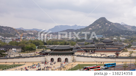 High-angle panoramic view of Gwanghwamun Gate and Gyeongbokgung Palace in Seoul, South Korea, with a large crowd. High-angle panoramic view of Gwanghwamun Gate and Gyeongbokgung Palace in Seoul, South Korea, with a large crowd. 138214358